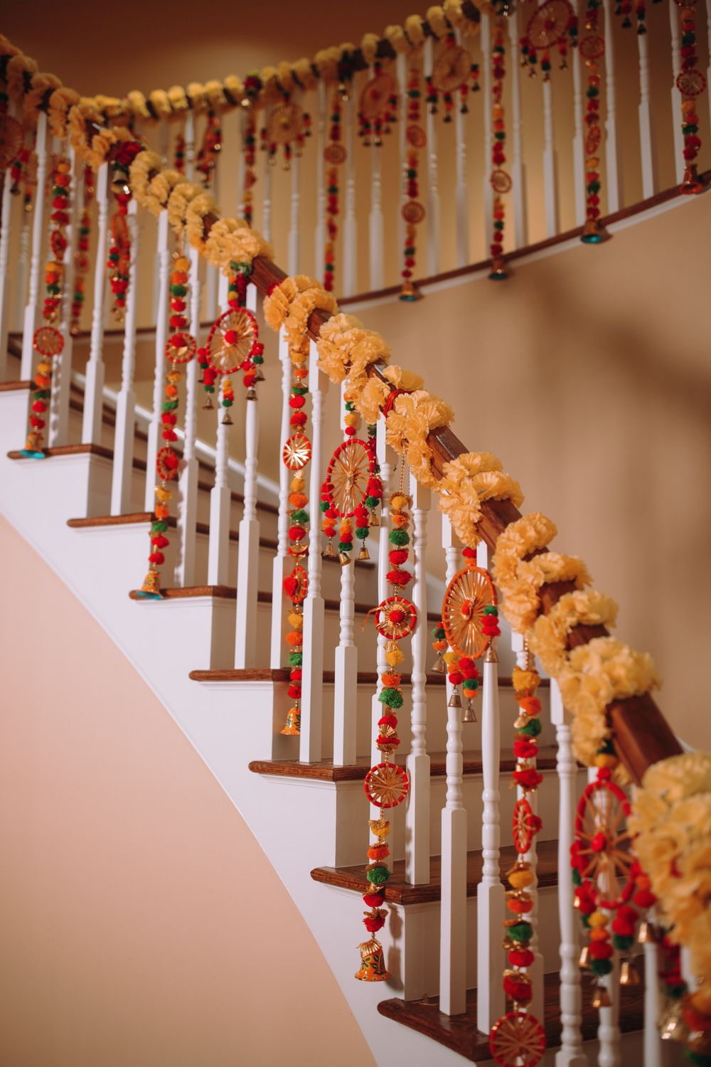 Staircase decorated with marigold garlands and red floral accents.