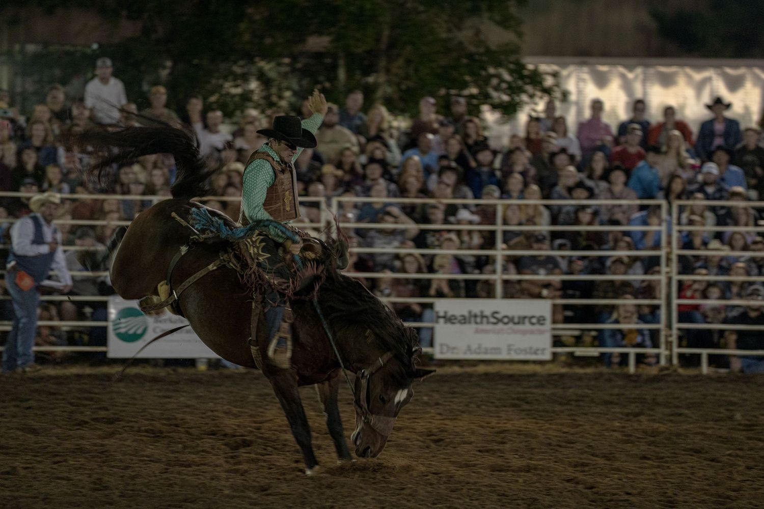 Cowboys compete in an intense rodeo event with multiple action shots showing roping and riding sequences in an arena.