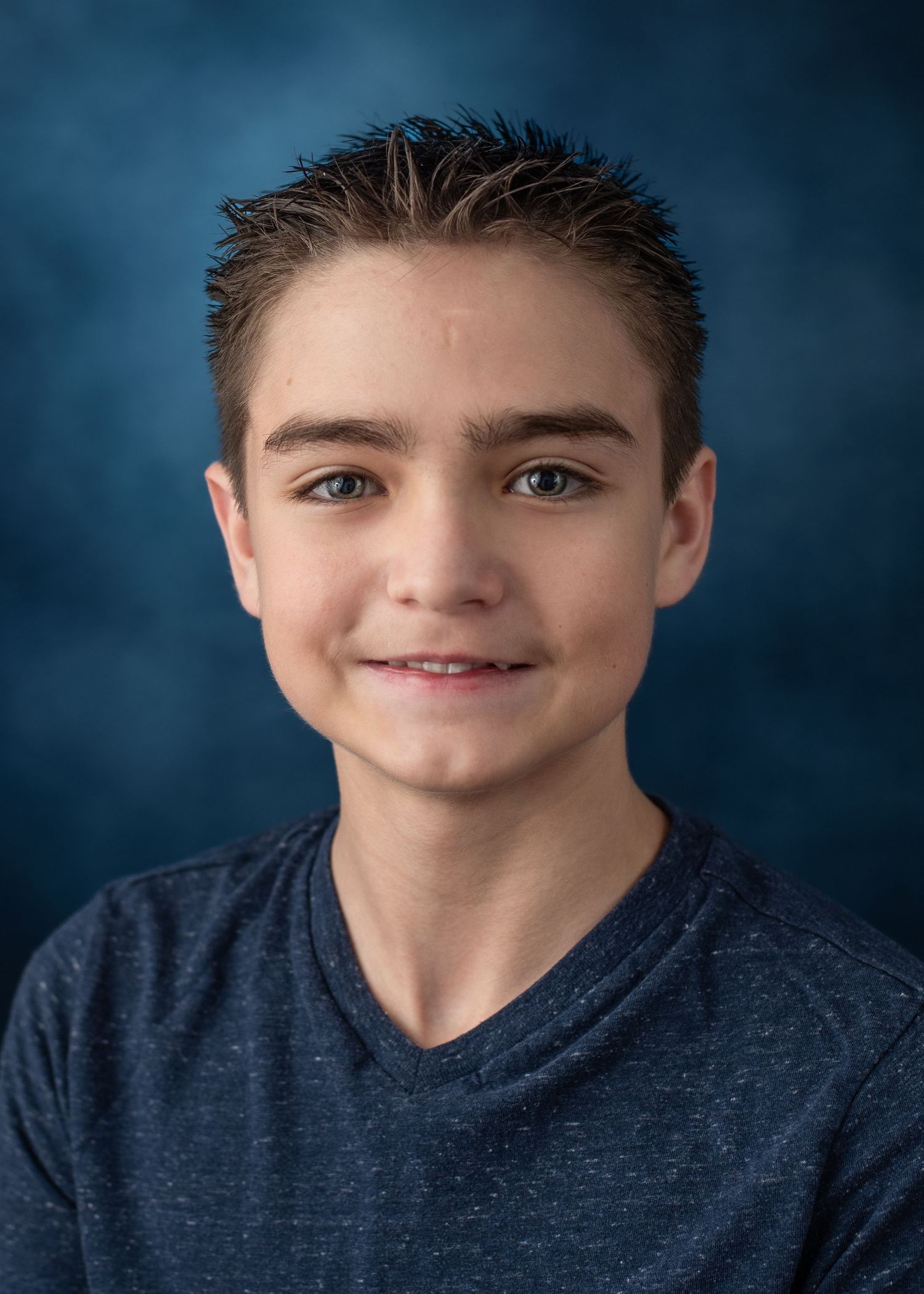 Studio portrait series showing different angles against deep blue background.