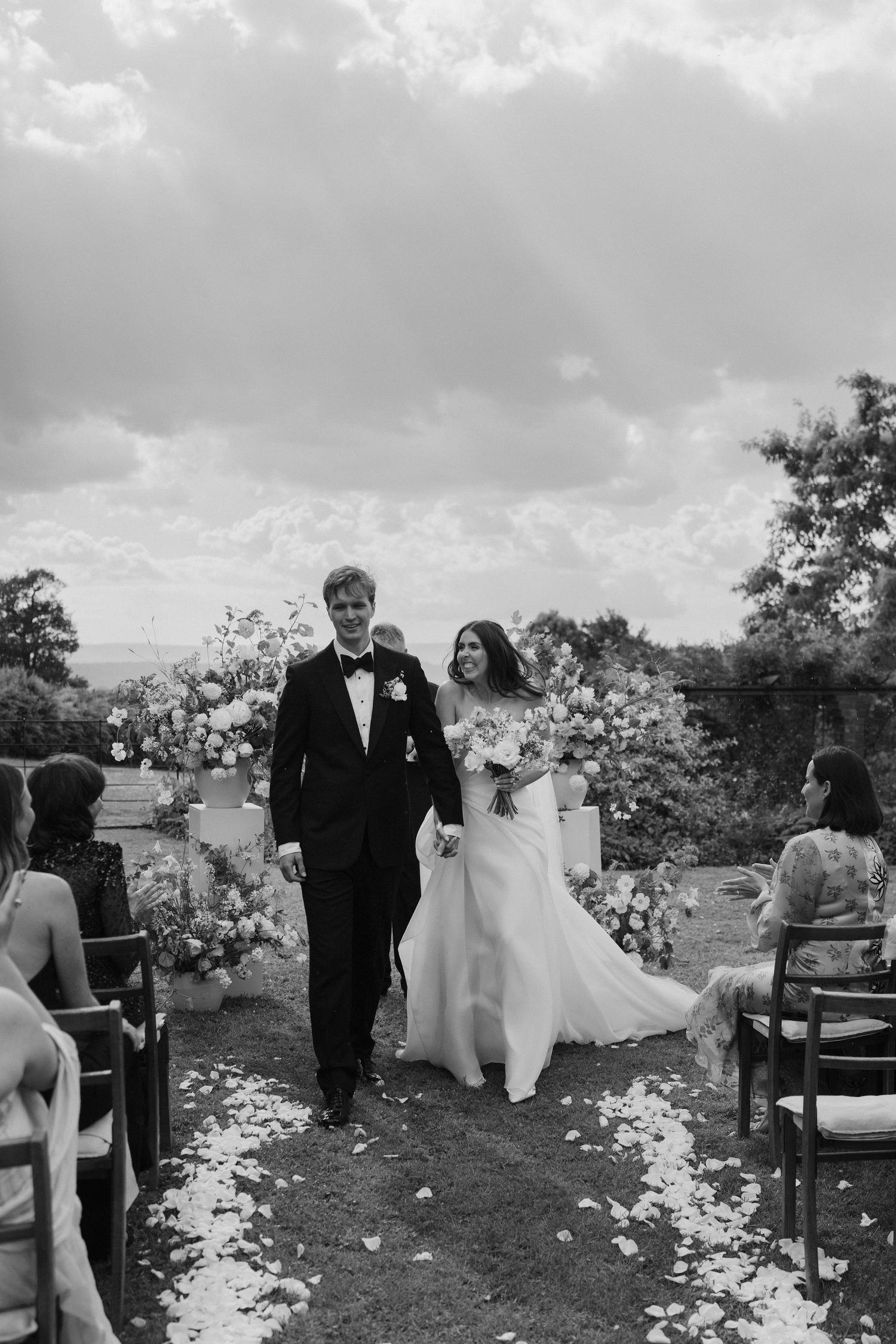 bride and groom coming down aisle as husband and wife, exiting their ceremony at dewsall court in herefordshire