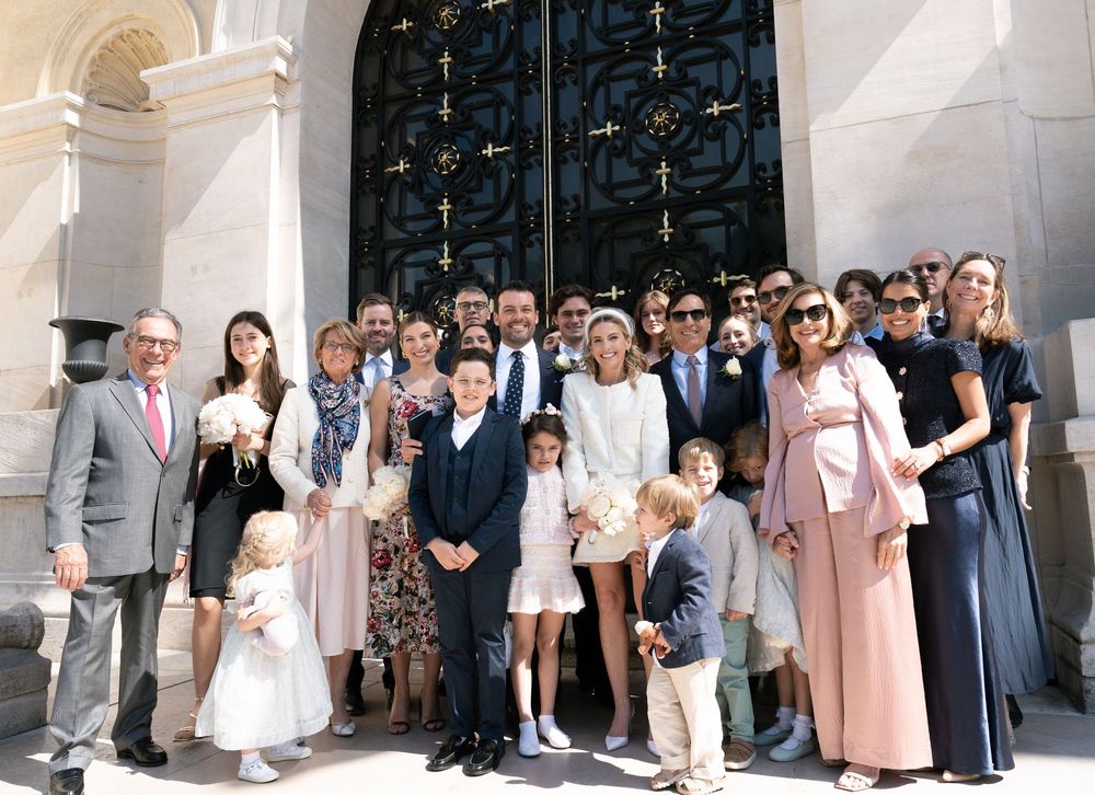 A panoramic collage of wedding guests posing for group photos outside a church entrance. Paris wedding on film.