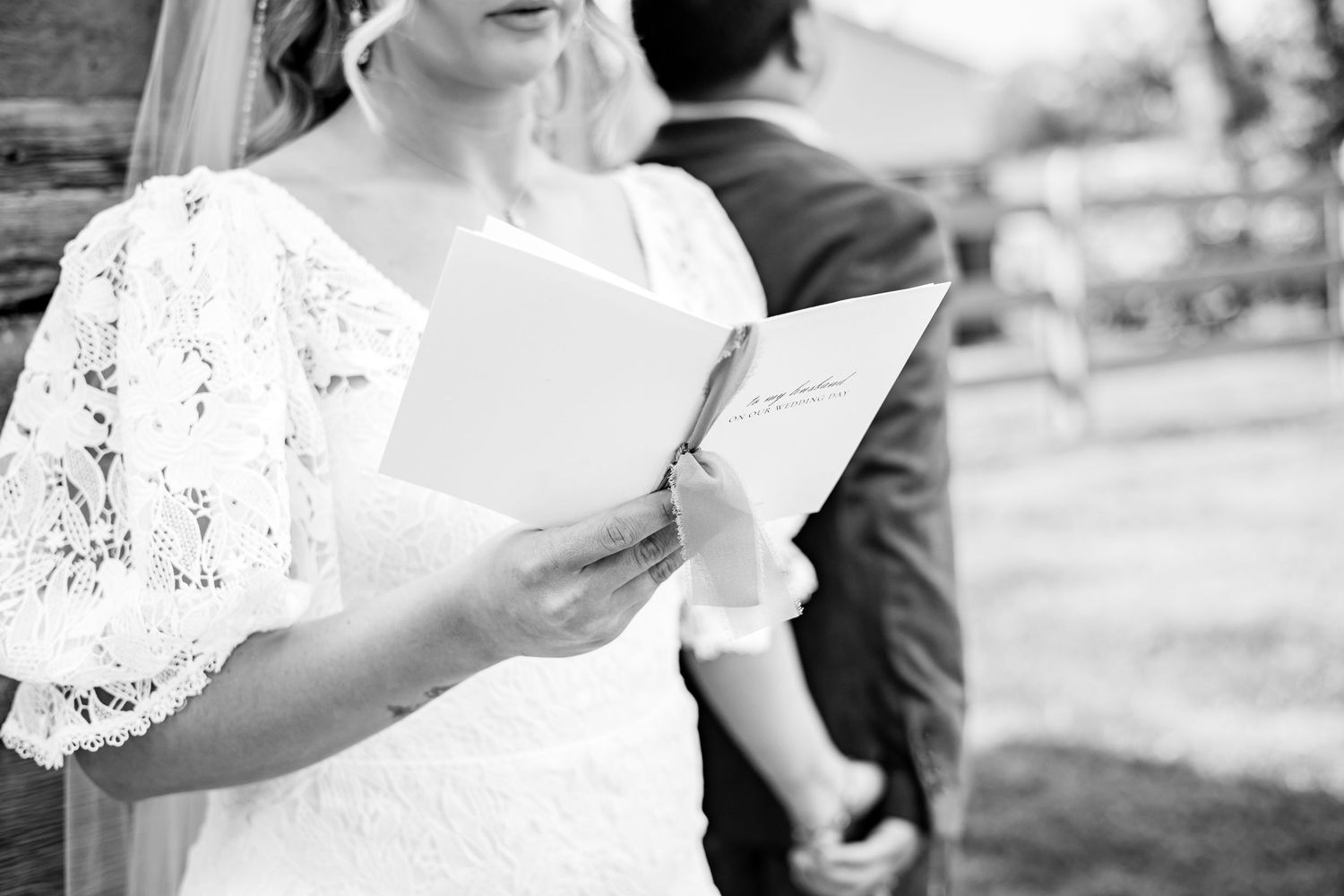 a bride reading from her vow book during a private vow exchange to her groom before their wedding ceremony