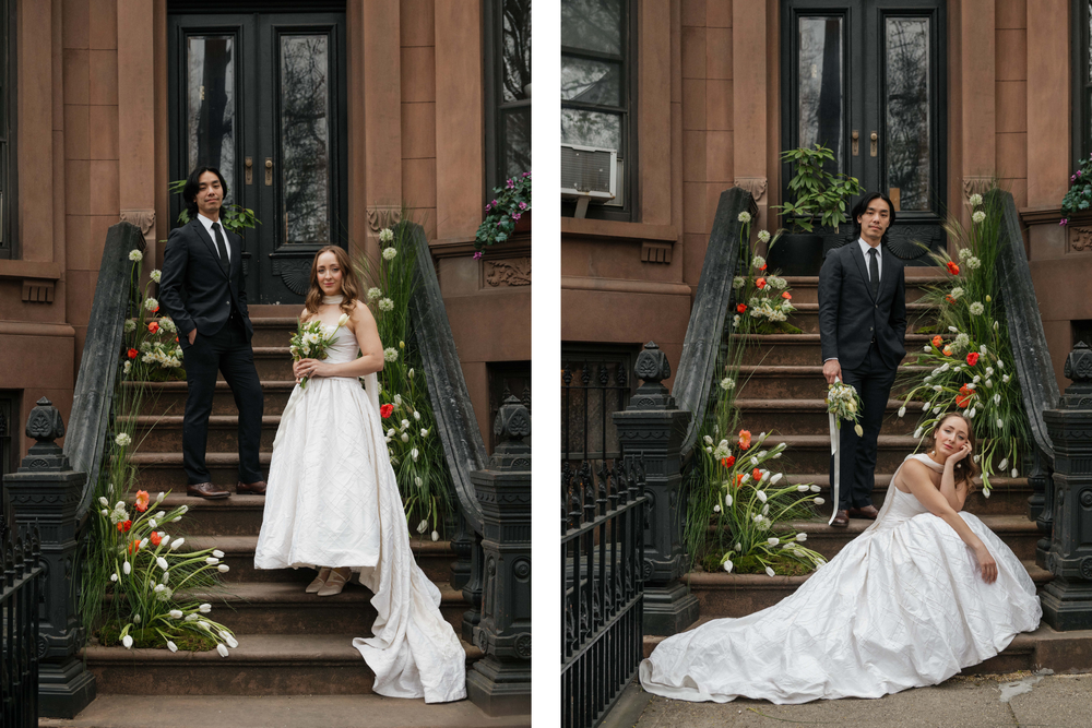Elegant wedding couple poses on brownstone steps decorated with autumn floral arrangements in warm fall colors.