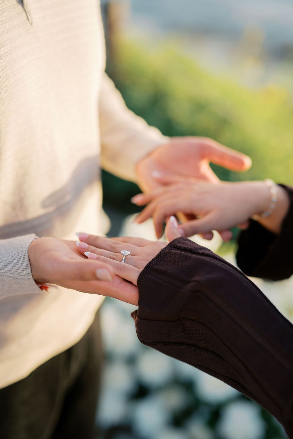 Close-up sequence showing hands exchanging a wedding ring during an engagement or proposal moment.