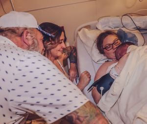 A tender moment captured in a hospital bed showing comfort and care.