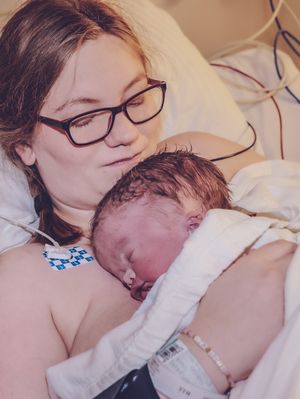 Intimate moments of bonding in a medical setting with hospital equipment visible.