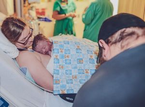 Medical staff attending to a newborn delivery in a hospital room.