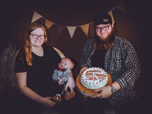 Panoramic view of family photo session with white banner decorations and moody lighting.