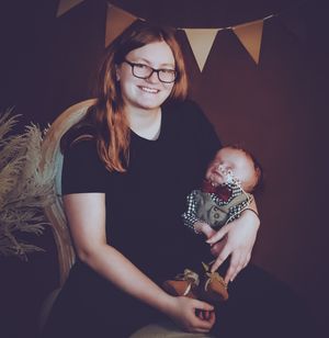 A family portrait with decorative bunting and pampas grass in warm atmospheric lighting.