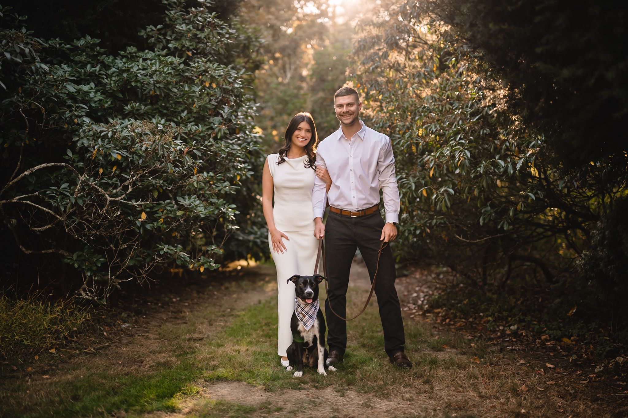 Sunset family portrait session in a wooded outdoor setting with natural lighting.