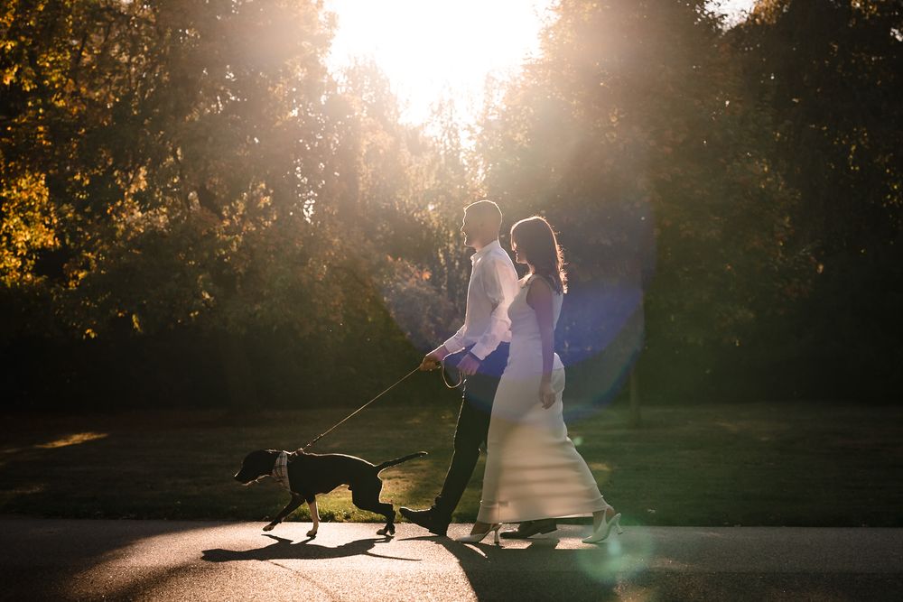 Silhouetted figures walk together on path during dramatic sunset lighting.
