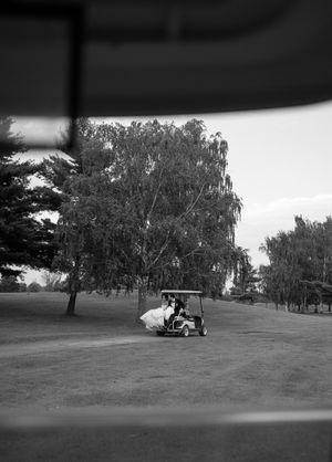 Black and white photo sequence of a golf cart driving across a scenic golf course with trees in the background.
