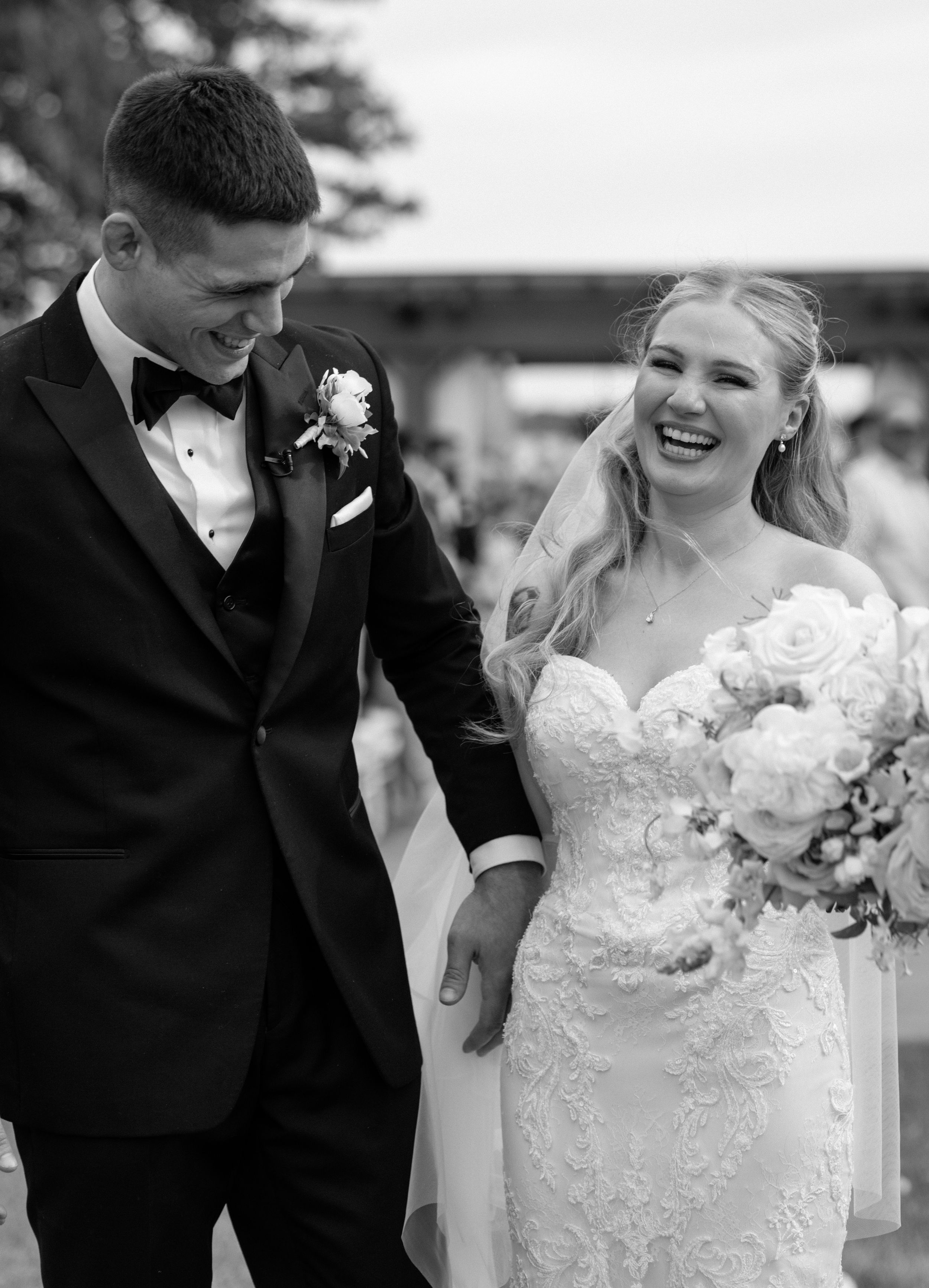 Black and white wedding photos show joyful moments between newlyweds holding bouquets and sharing laughter outdoors.