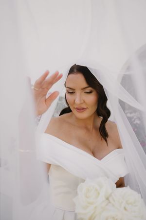 A series of ethereal bridal portraits showing a white wedding dress and veil against a light background.