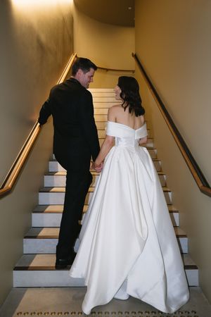 A sequence of wedding photos showing a couple ascending stairs, with the bride wearing a white gown and groom in black suit.