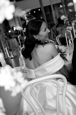 Black and white wedding photo sequence showing bride in white dress looking over her shoulder in elegant reception setting.