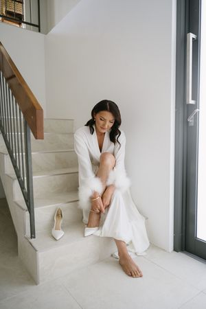 Minimalist bridal portrait in white room with staircase.