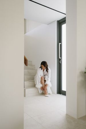 Modern white interior with staircase and natural lighting.