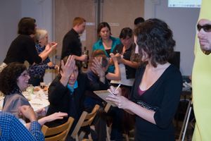 Engaged audience members participating in group discussion during professional workshop.