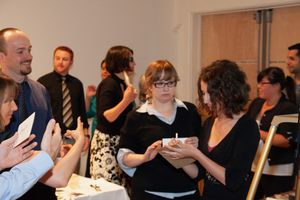 Workshop participants engaged in animated discussion at professional training event.