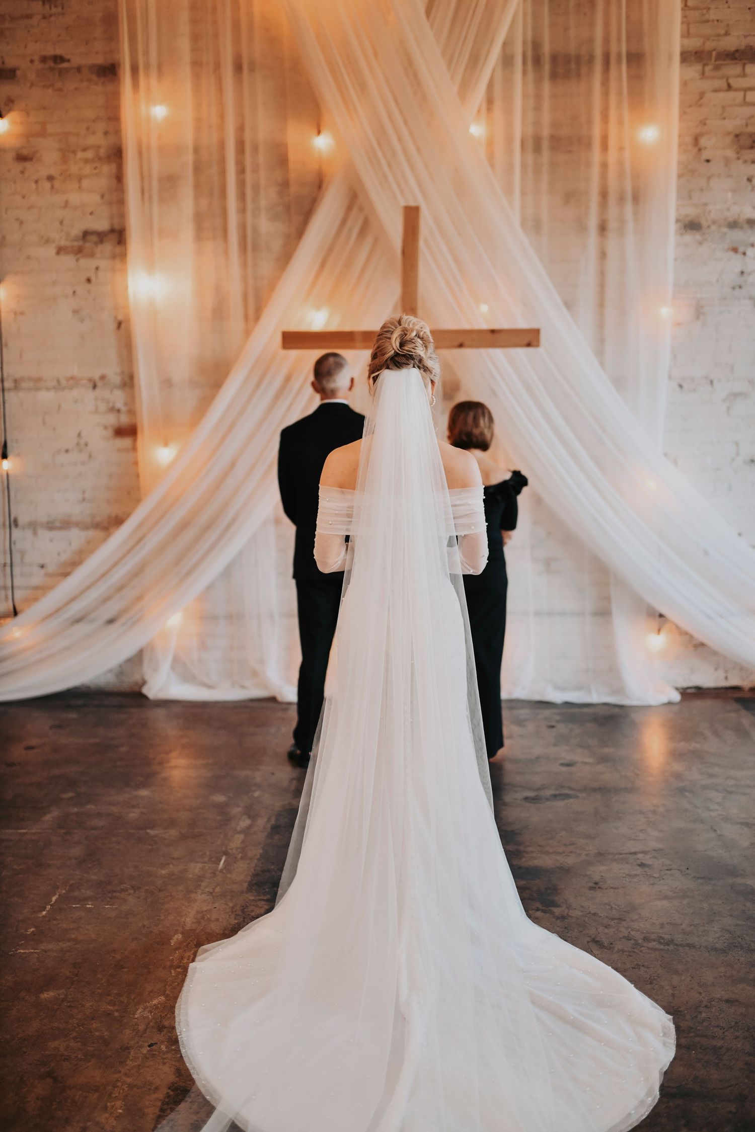 Bride revealing her dress to parents during first look moment