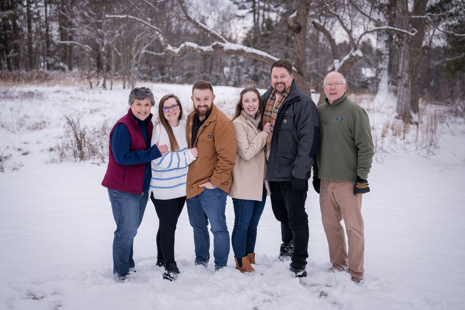 Family group photos showing everyone walking and posing together in winter scenery.