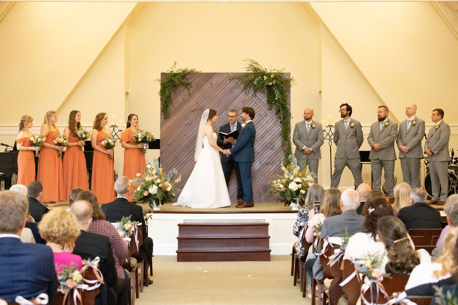 A series of wedding ceremony photos showing different moments during indoor church ceremonies with floral decorations.