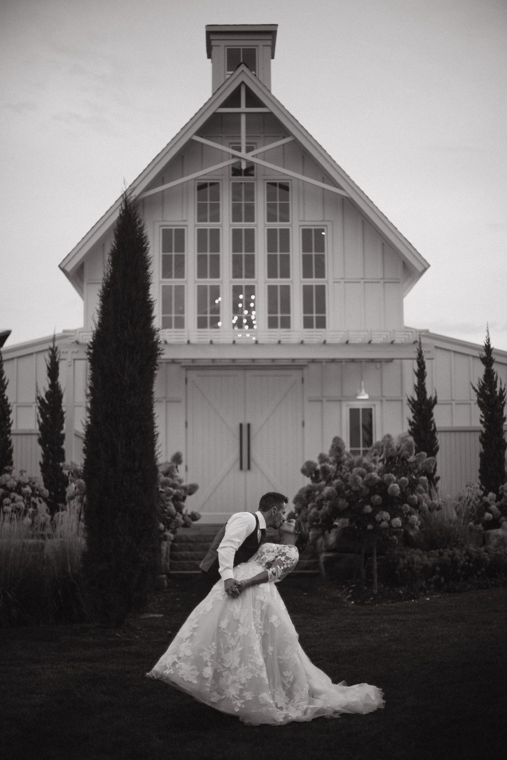 White barn wedding venue with classic architecture photographed in black and white.