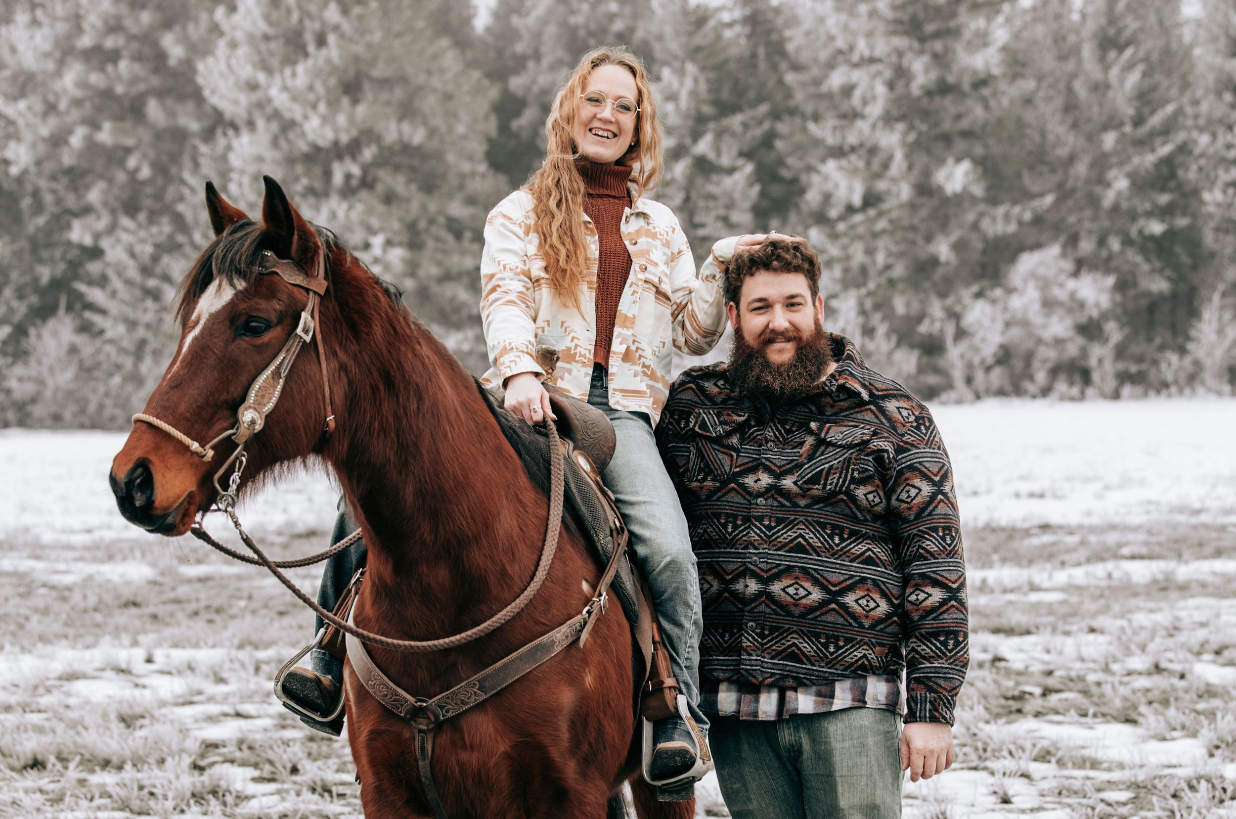 Cle Elum, WA Engagement session woman sitting on a horse with her hand on top of mans head.