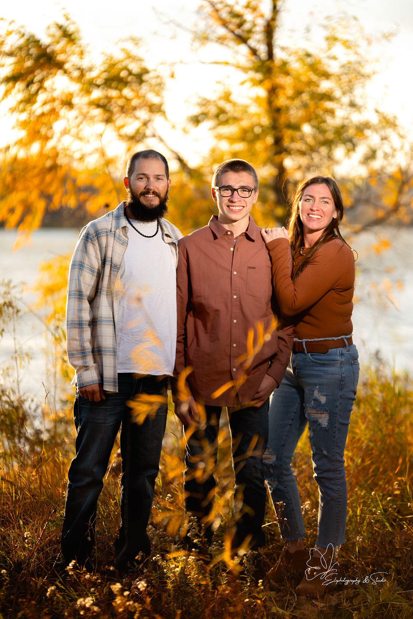 Casual family photo shoot in autumn setting with warm golden light in Williston, North Dakota.