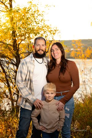 Candid family moment captured during sunset photo session in nature in Williston, North Dakota.