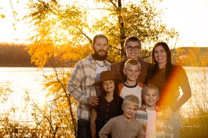 Natural family portraits with golden autumn trees and sunset lighting in Williston, North Dakota.