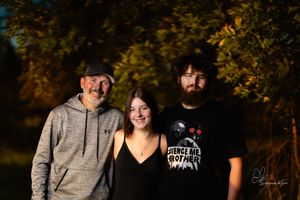 Evening outdoor portrait session with moody lighting and autumn foliage in Pierre, South Dakota.