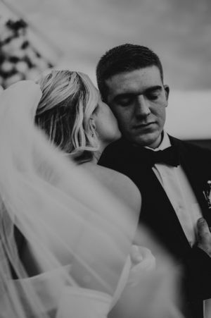 Black and white romantic wedding photos showing tender moments between newlyweds.