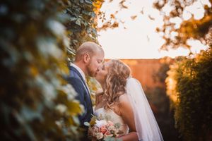 Golden hour wedding portraits with warm autumn lighting.