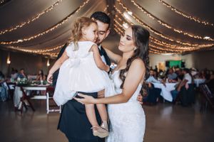 Wedding reception dance floor moments under twinkling string lights.