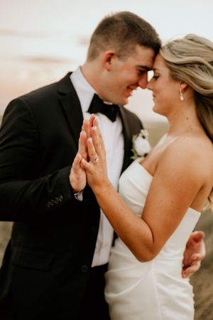 Romantic close-up moments during sunset wedding portraits.