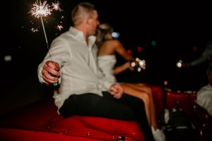 Wedding reception nighttime celebration with sparklers creating magical light trails.