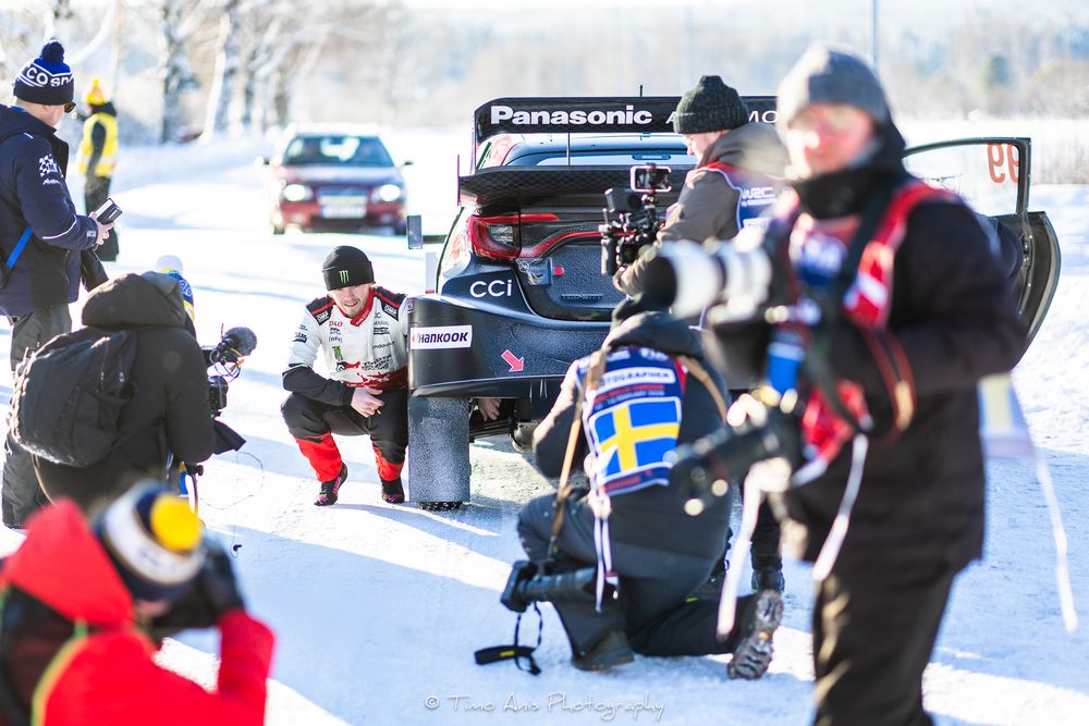 Rally cars racing through snowy winter terrain during an intense competition.