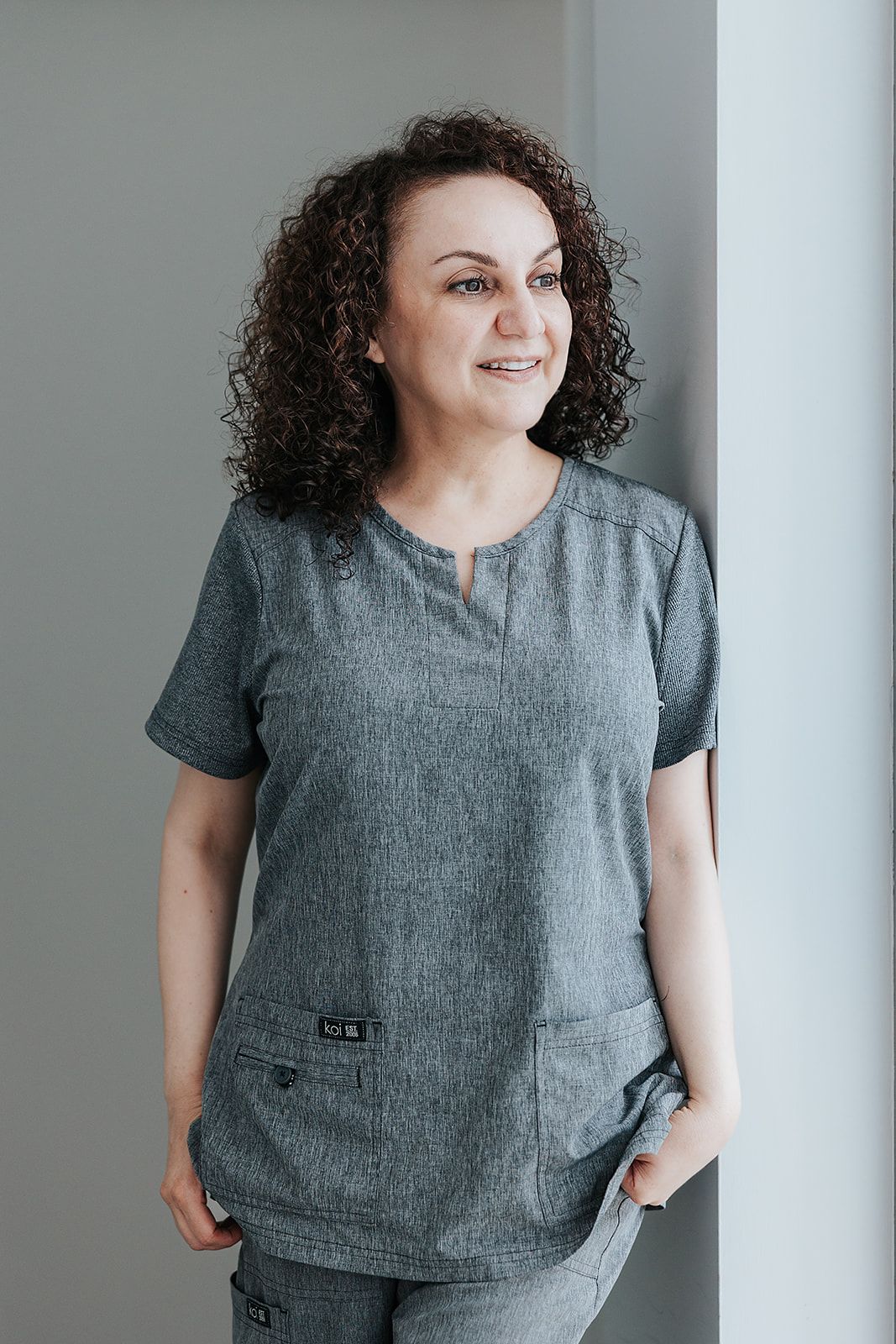 A series of photos showing a gray linen top with short sleeves and relaxed fit against a light background.