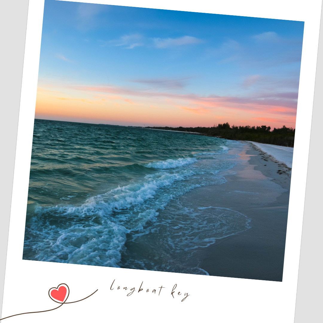 Serene coastal sunset over a beach with gentle waves rolling onto the shore and turquoise waters stretching to the horizon. Longboat Key FL