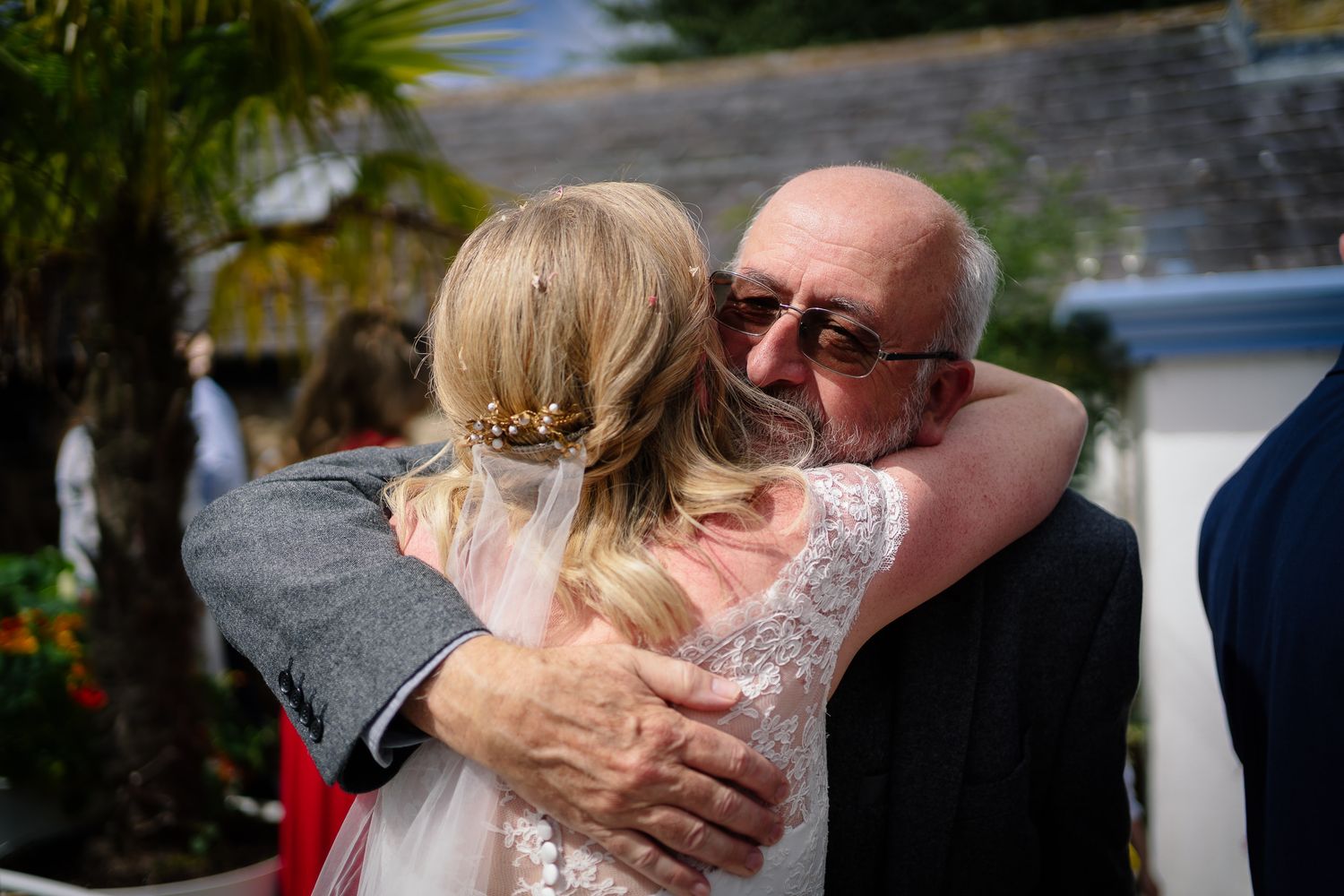Candid moments of celebration and hugs during outdoor wedding reception. Woodhill Hall.