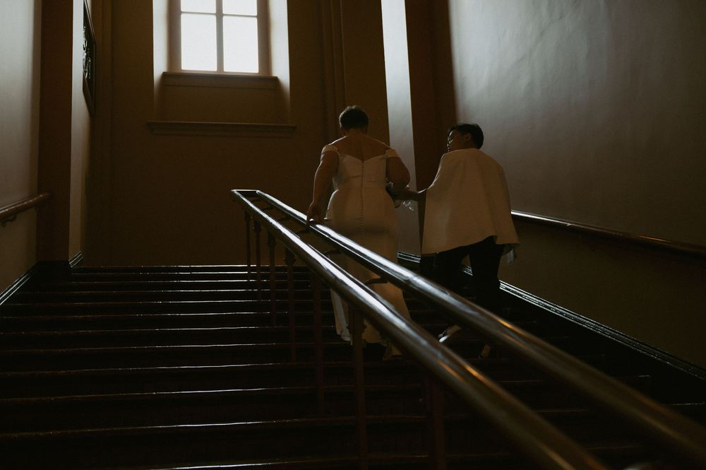 Moody interior stairwell photo with dramatic shadows and natural window lighting.