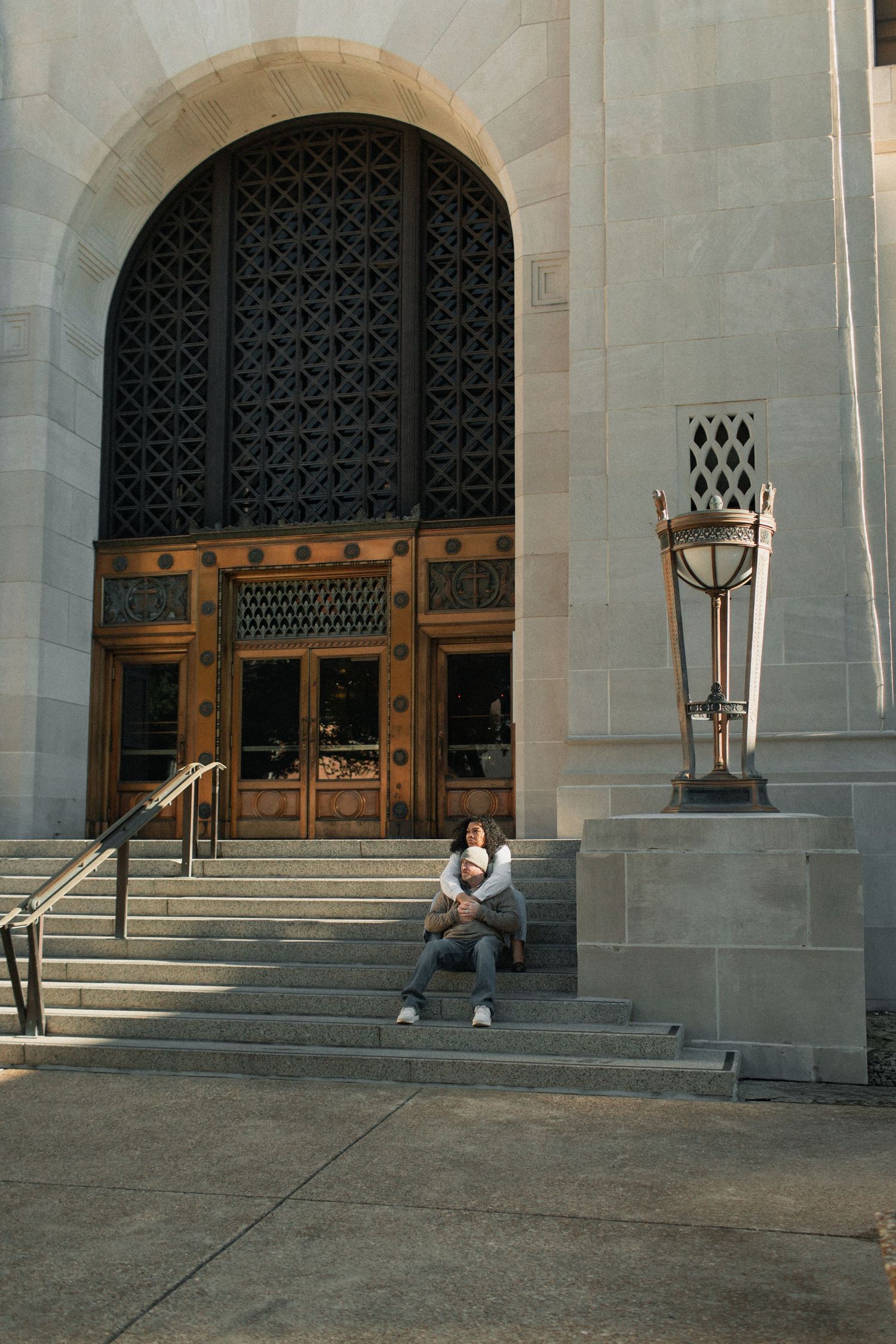 Four sequential photos show a person sitting alone on stone steps in front of large arched wooden doors of a building.