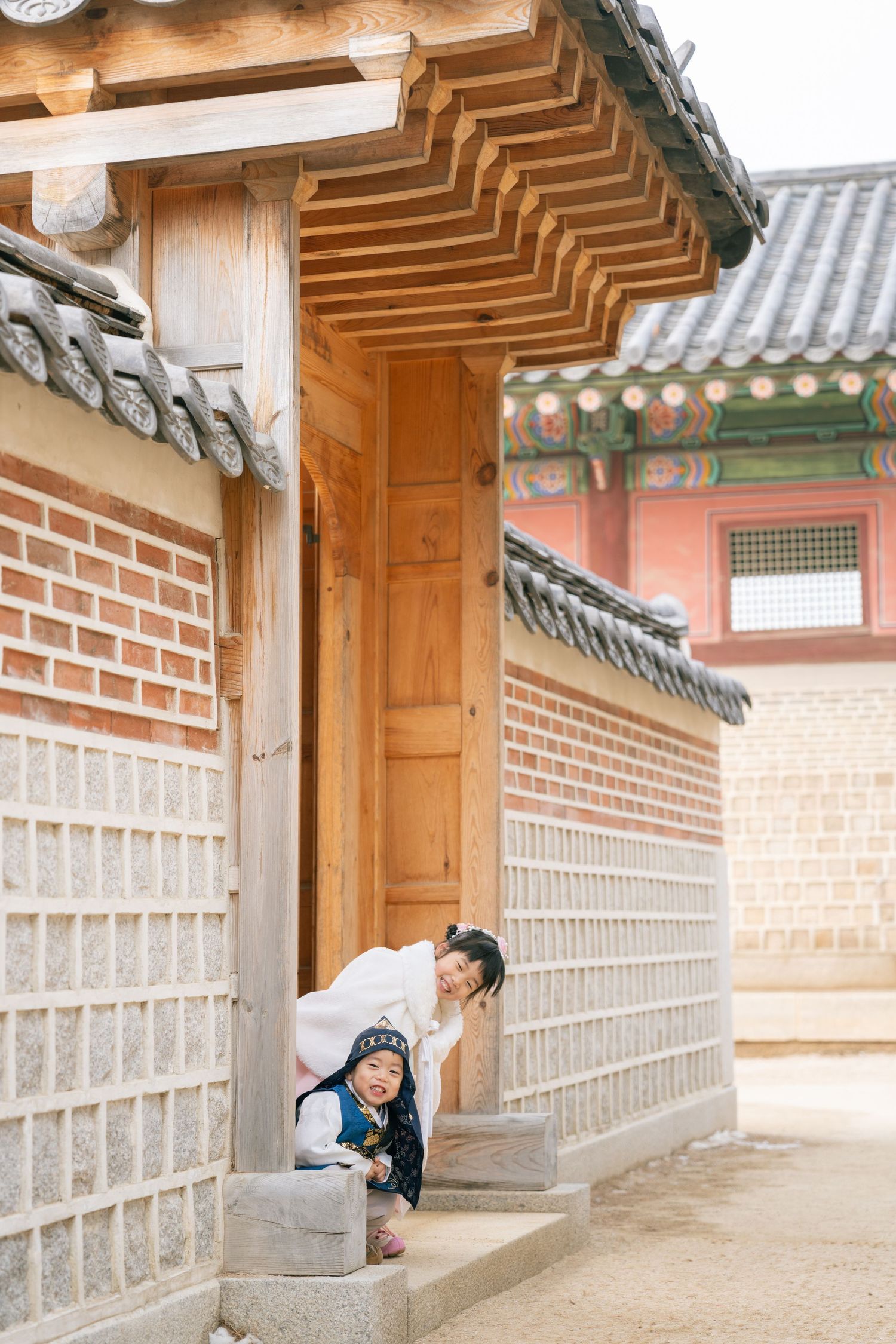Traditional Korean hanok building exterior with wooden pillars and tiled roof details at Changdeokgung Palace in Seoul.