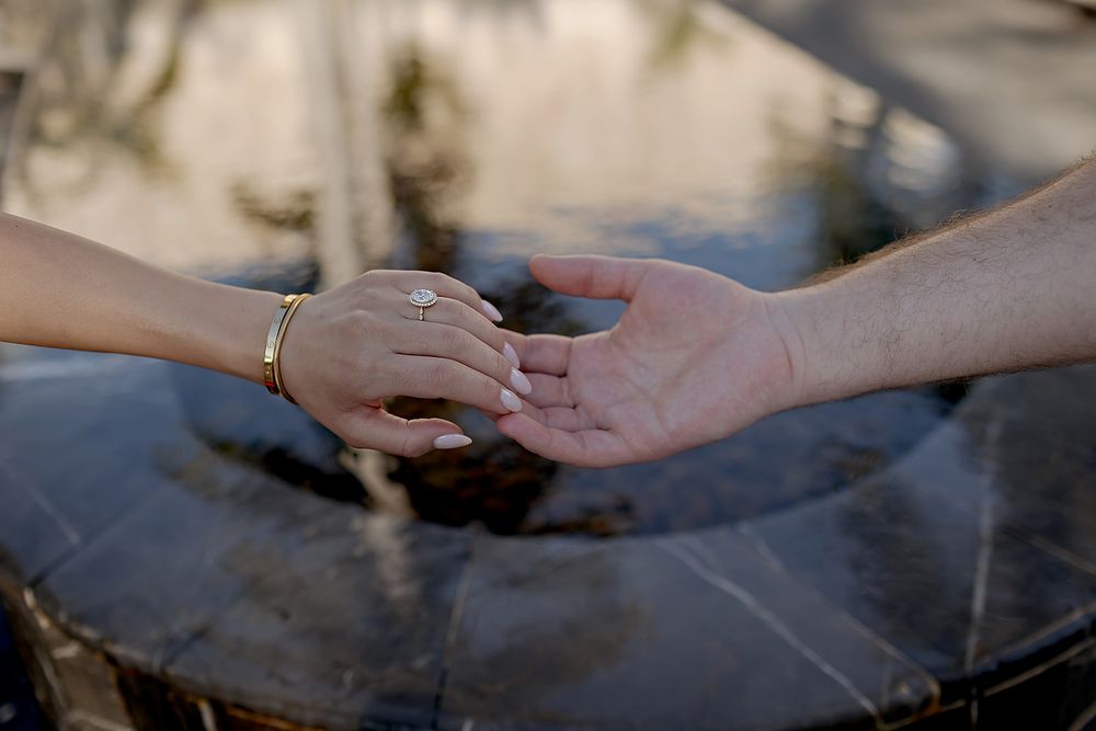 Close-up sequence showing hands preparing and cooking meat on a smoky grill surface.