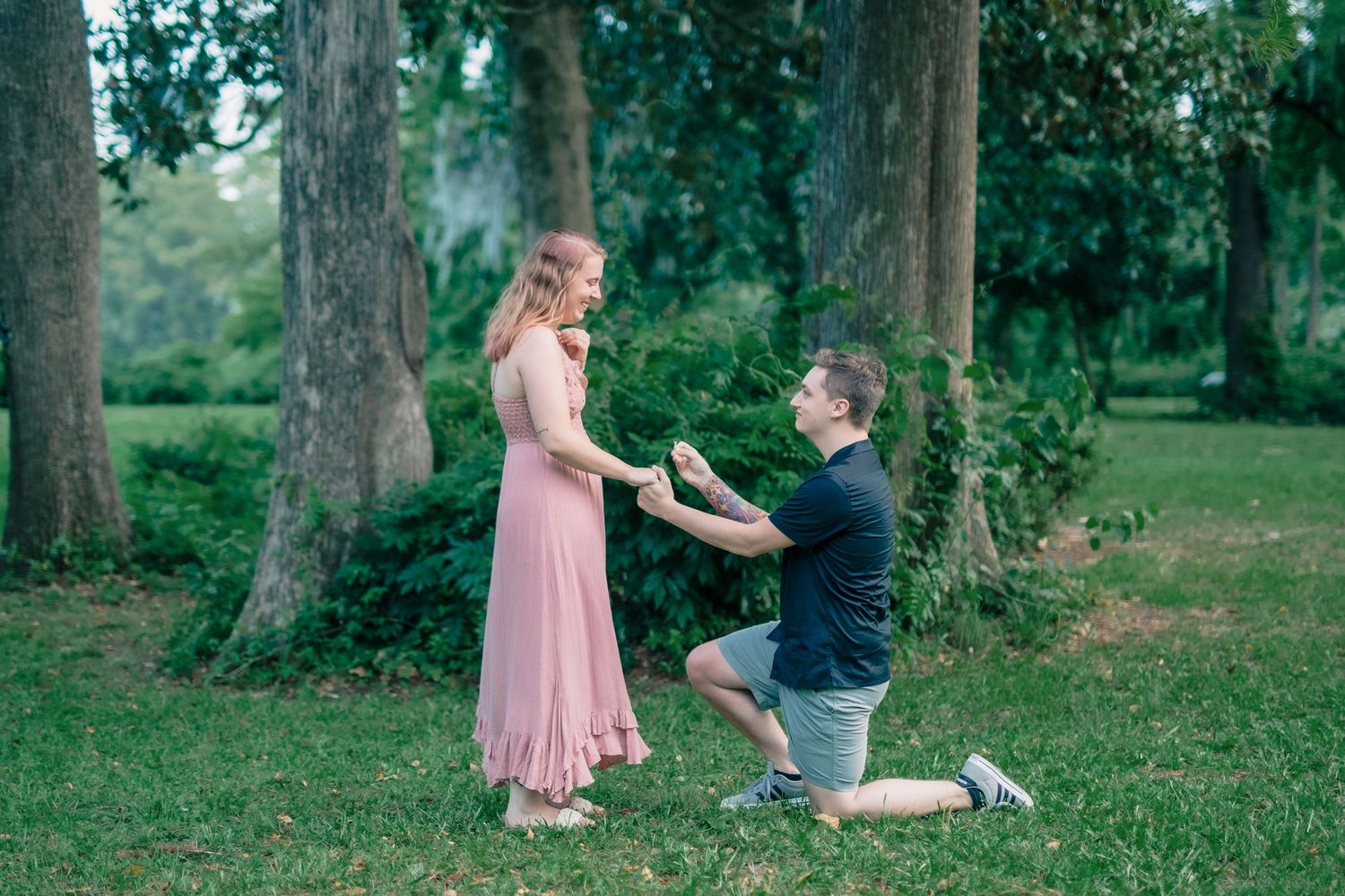 Emotional moment of surprise proposal under trees in Amherstburg Ontario.