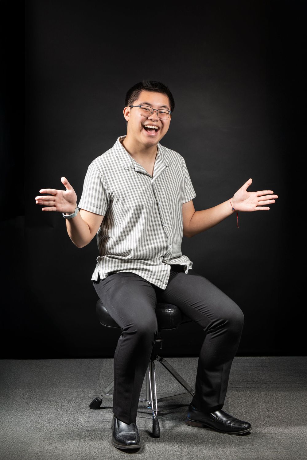 A sequence of photos shows a person in a striped shirt and dark pants gesturing expressively while seated against a black backdrop.