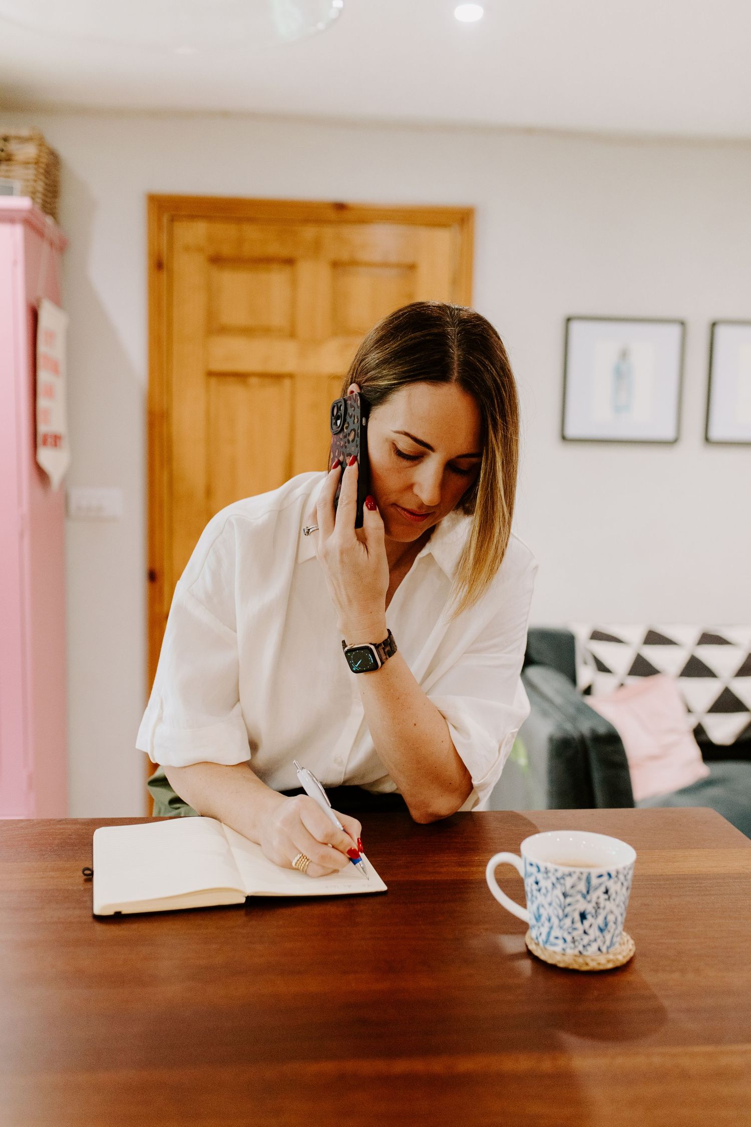 A sequence of images showing someone in a white shirt working at a wooden table with a decorative coffee mug.