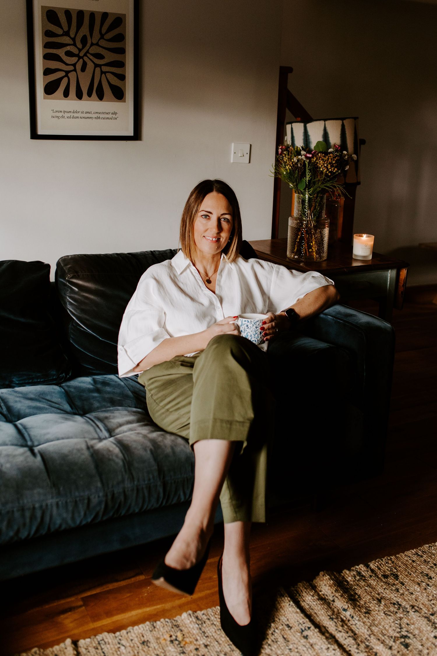 A series of moody photos showing someone lounging on a dark blue velvet couch against a warm-toned wall with artwork.